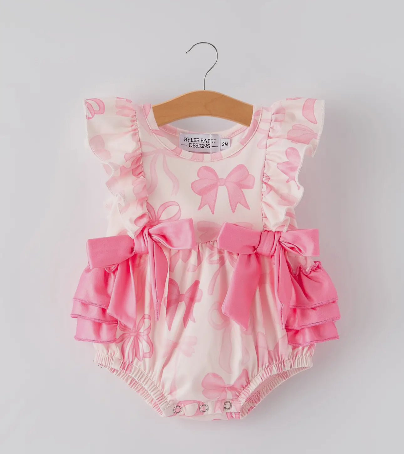 Get your little one ready for the summer with our Girls Pink Bow Print Romper! Made with soft and breathable fabric, this romper features an adorable bow print design that will make your little girl stand out. Perfect for any occasion, it's a must-have fo
